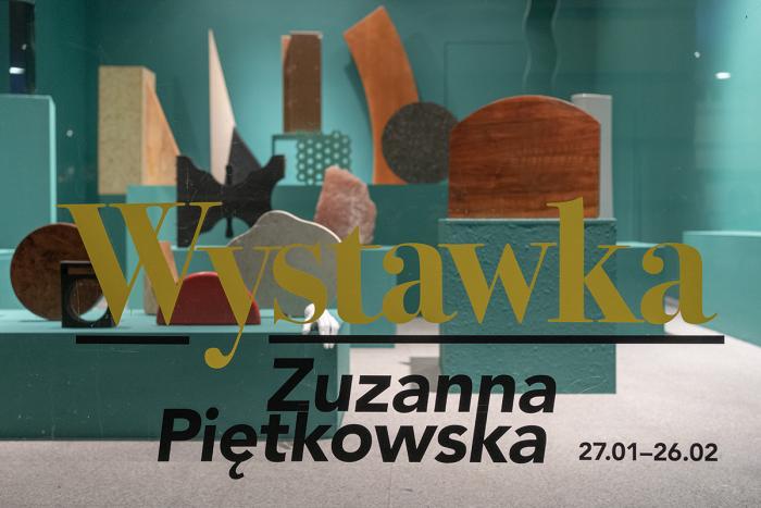 zdjęcie wystawy a szybą, ustawione przedmioty, napis wystawka